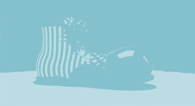 Striped clown shoe with polka dots on blue background, playful footwear