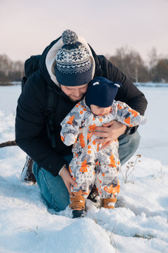 Father and Baby Enjoying Snowy Day Together.