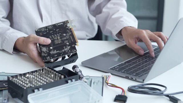 Computer engineer using laptop programing graphic card driver