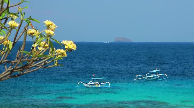 Traditional Balinese Snorkeling diving boat floating on vibrant ocean waves in Bali