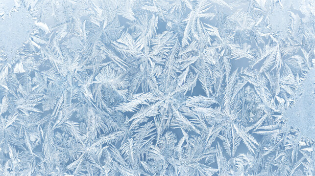 Intricate frosty patterns on a window pane in winter