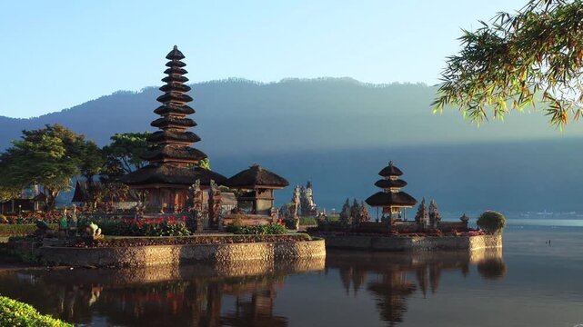 Iconic Balinese Traditional water Temple among the lake and mountains in the morning lights