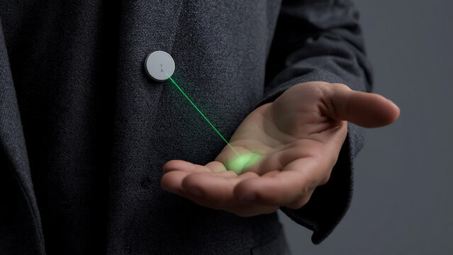 Person holding glowing orb in hand with green line
