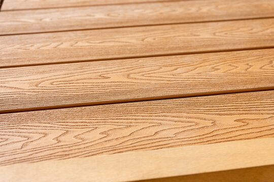 Wood plastic composite WPC boards with natural wood look. Durable decking, facade and fencing material for modern outdoor use.