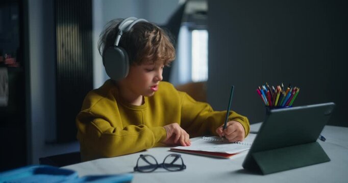 Young Person Drawing Thoughtfully. Teenage Male Concentrating On Sketching And Writing In His Notebook