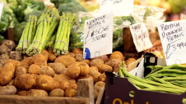 Fresh vegetables for sale at market a cinematic clip panning shot captures the vibrant display.