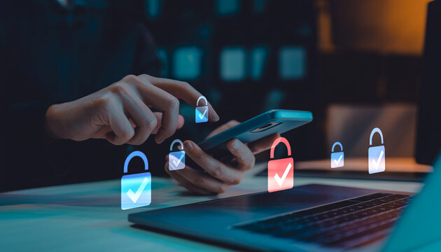 Person holding smartphone in hand while interacting with digital security icons representing cyber protection and verified access to personal information in modern work environment.