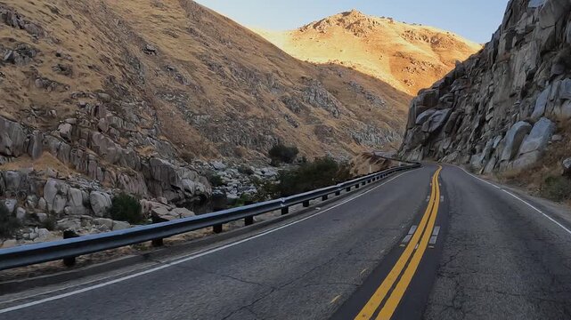 POV driving scenic highway in rugged, rocky river canyon in California