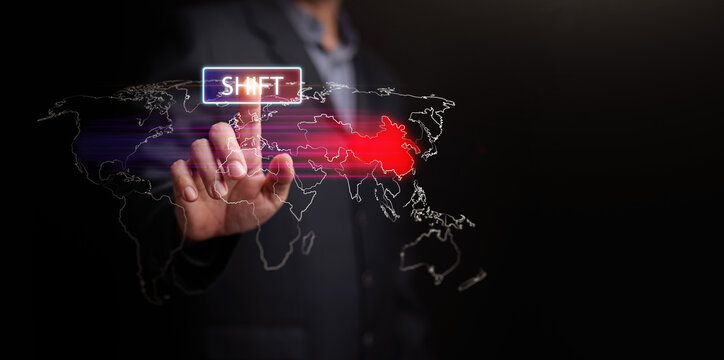 Finger pressing SHIFT above the digital world map showing power shifting from West to East. Rising China, declining US influence, geopolitical transition, economic change, and strategic realignment.