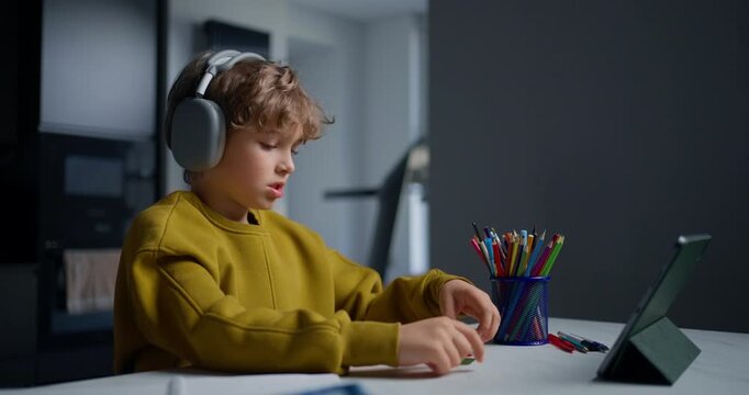 Young Boy Carefully Looks At Bright Shape Cards While Participating In Digital Learning Session