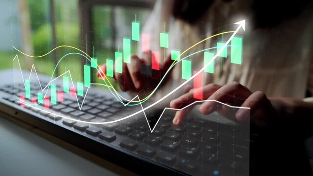 Close-up of hands typing on a keyboard with a digital financial chart overlay, illustrating growth and analysis in a contemporary workspace. Copula