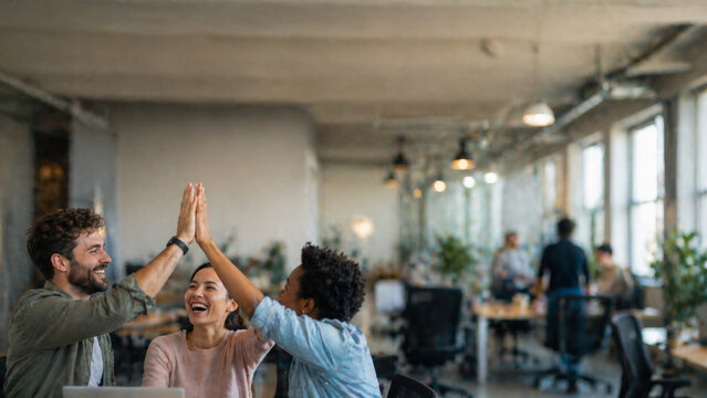 Happy colleagues high five office team