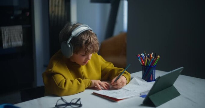 Focused Student Working. Motivated Child Diligently Completing Educational Tasks In Peaceful Learning Space