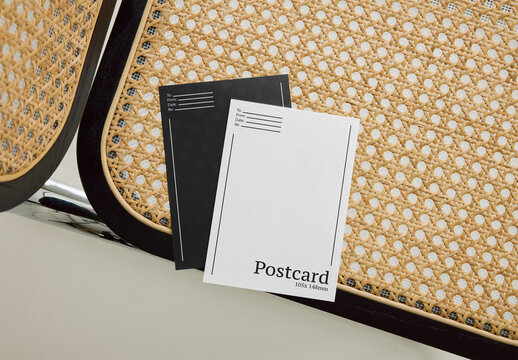 Mockup Of Two Customized Post Cards On Chair