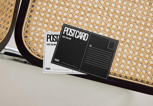 Mockup Of Two Customizable Post Cards On Chair