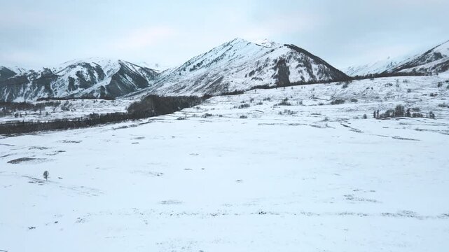 Aerial View of Ice-Covered Snow Mountains and Frozen Alpine Landscape in Winter
