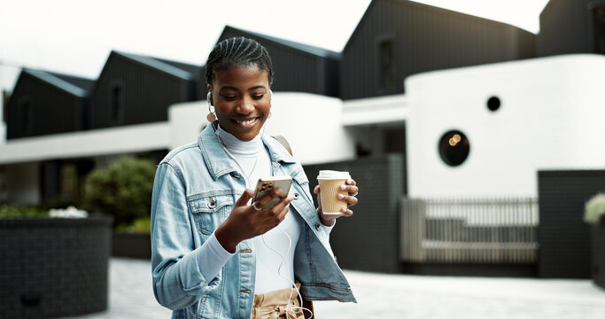 Walking, phone and black woman in city with earphones for music, thinking and morning commute. Happy, travel and person with coffee and cellphone for streaming audio, podcast and playlist in town