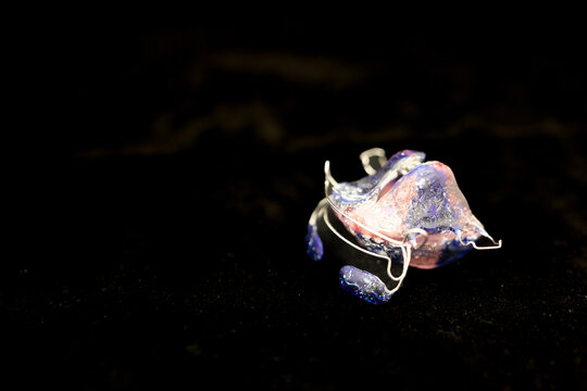 Orthodontic plate appliance on dark background dental device