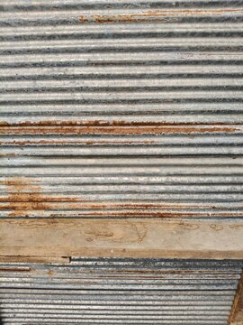 Close up texture of old weathered corrugated metal sheet surface for background and pattern.
