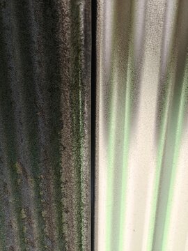 Close up texture of old weathered corrugated metal sheet surface for background and pattern.
