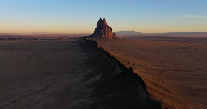 Aerial view of Shiprock, a culturally significant landmark in Navajo Nation. Towering rock formation surrounded by vast desert landscape in the American Southwest