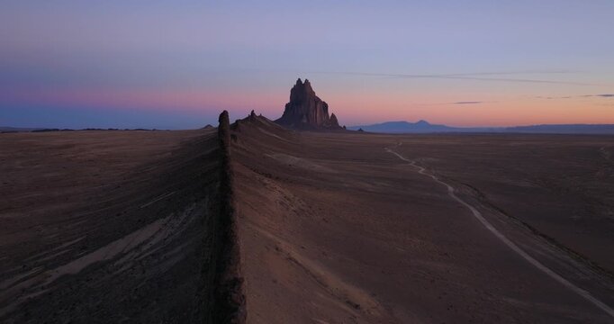 Drone shot emphasizing textures, lines, and natural patterns in the desert landscape with Shiprock as a focal point in the composition