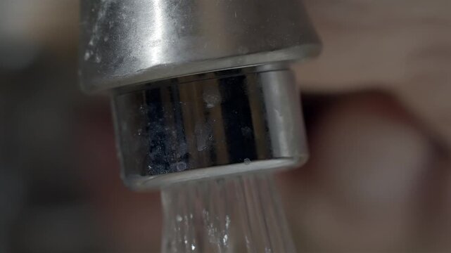 Turning on the waters from a calcified metallic tap in a blocked drain
