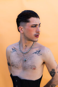 Young person expressing individuality with makeup and tattoos