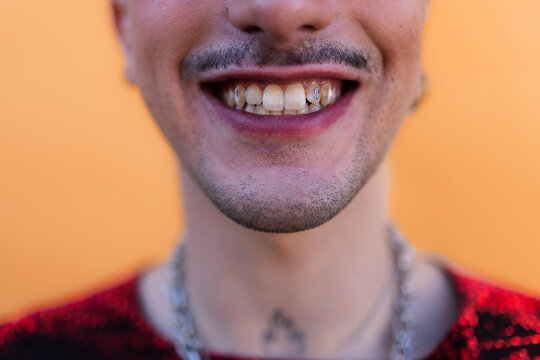 Person smiling showing tooth gem tooth jewelry dental fashion