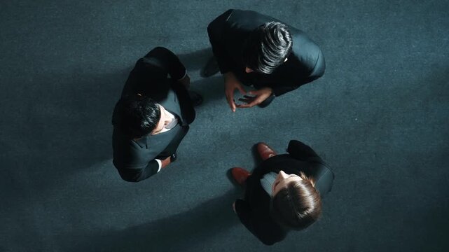 Top down aerial view of diverse business team explain marketing strategy while standing and looking at camera in meeting room. Group of smart people brainstorming and discuss plan. Directorate.