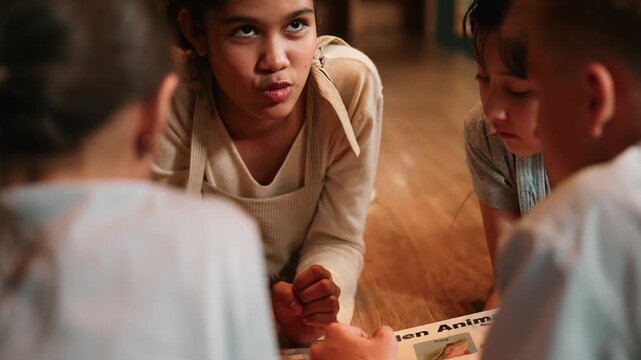 Caucasian girl sharing experience while reading a book together with multicultural friend at library. Group of happy diverse student talking while learning or study english from book. Edification