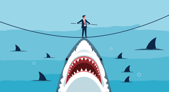 Brave businessman walking on a tightrope over the open jaws of a massive shark to illustrate the high risks involved in business ventures.