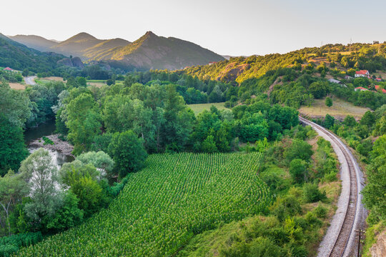 Railway tracks running through the mountainous countryside of the Ibar river valley around village of Brvenik in Raska district, Serbia
