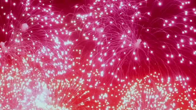 Colorful fireworks burst brightly against night sky, creating dazzling display of lights and patterns. Spectacular celebration brings joy and excitement to everyone watching in city below.
