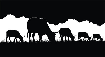 Fototapeta premium Silhouette of a herd of deer grazing in a field at dusk