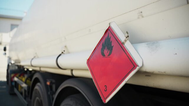 Fuel truck flammability hazard symbol at gas station filling up petrol