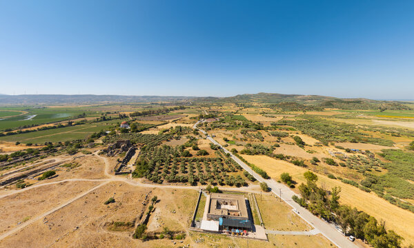 Balat, Didim, Turkey. Aerial view of Ilyas Bey Kervansarayi caravanserai and Ilyas Bey Kulliye complex with modern village, hills and agricultural fields. Aerial view
