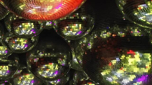 Dazzling disco balls illuminate a fantastic birthday party night. Brilliant kaleidoscopic lights dance across the floor, setting a lively mood for friends celebrating a special occasion.