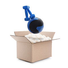 Medicine ball and dumbbells falling into cardboard box with styrofoam cubes on white background