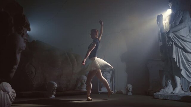 Enjoy classical arts and visit theatres, beautiful ballerina dancing in museum. Graceful ballet dancer performing beautiful dance in darkness, silhouette of woman in white tutu and pointe shoes