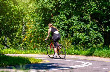 Naklejka premium Cyclist ride on the bike path in the city Park 