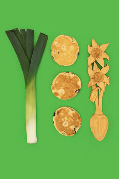 National symbols of Wales culture, dragon flag, daffodil love spoon, leek, welsh cakes on green background. Traditional Cymru items.