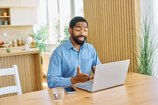 Portrait of a young blackman with laptop at home office