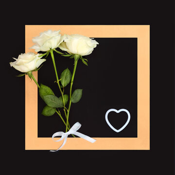 White rose flower bouquet for loving funeral tribute card. Rest in peace farewell concept on dark gray background with gold frame with white heart.
