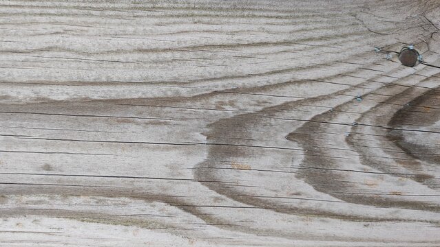 Wood texture gray background with signs of natural weathering defects and seasoning checks