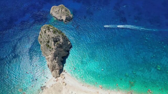 Spectacular view of Mizithres sea stacks and white limestone cliffs in Zakynthos. Crystal turquoise water and dramatic coastline of the Ionian Sea in a scenic Greek island landscape.