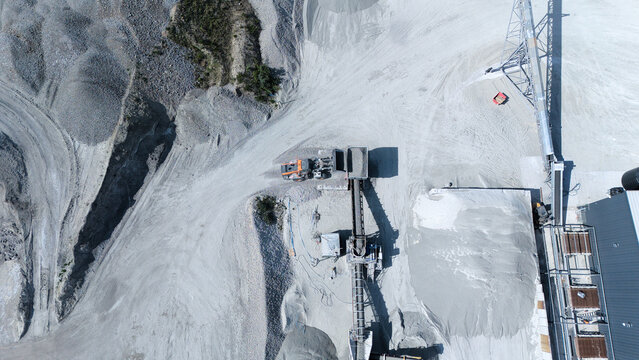 Aerial view of the Foamed Glass Industrial Factory with conveyor belts, heavy machinery, and piles of grey material in Great Heck, England, United Kingdom.