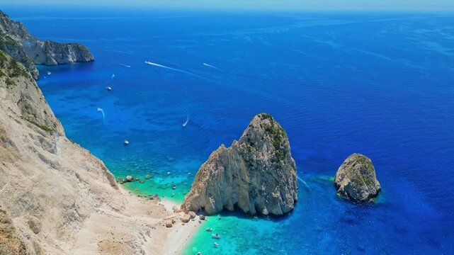 Spectacular view of Mizithres sea stacks and white limestone cliffs in Zakynthos. Crystal turquoise water and dramatic coastline of the Ionian Sea in a scenic Greek island landscape.