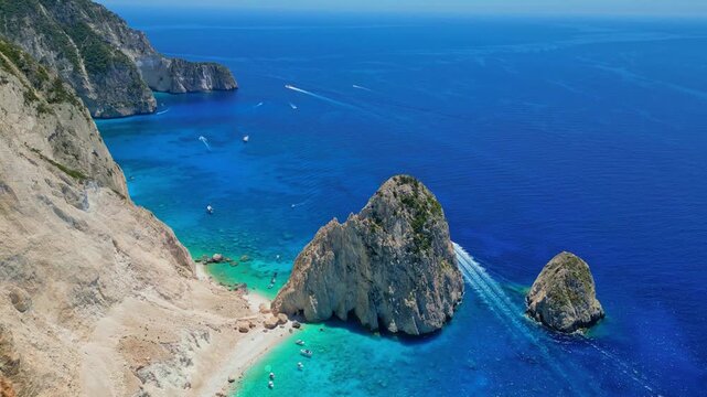 Spectacular view of Mizithres sea stacks and white limestone cliffs in Zakynthos. Crystal turquoise water and dramatic coastline of the Ionian Sea in a scenic Greek island landscape.