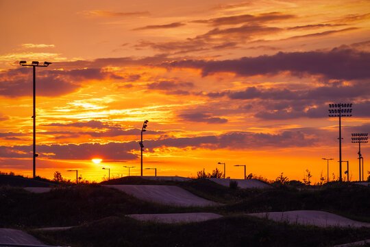 Sunset at the BMX track (bicycle motocross racing track) at Lee Valley VeloPark in Stratford, East London, UK, with a moody sky
